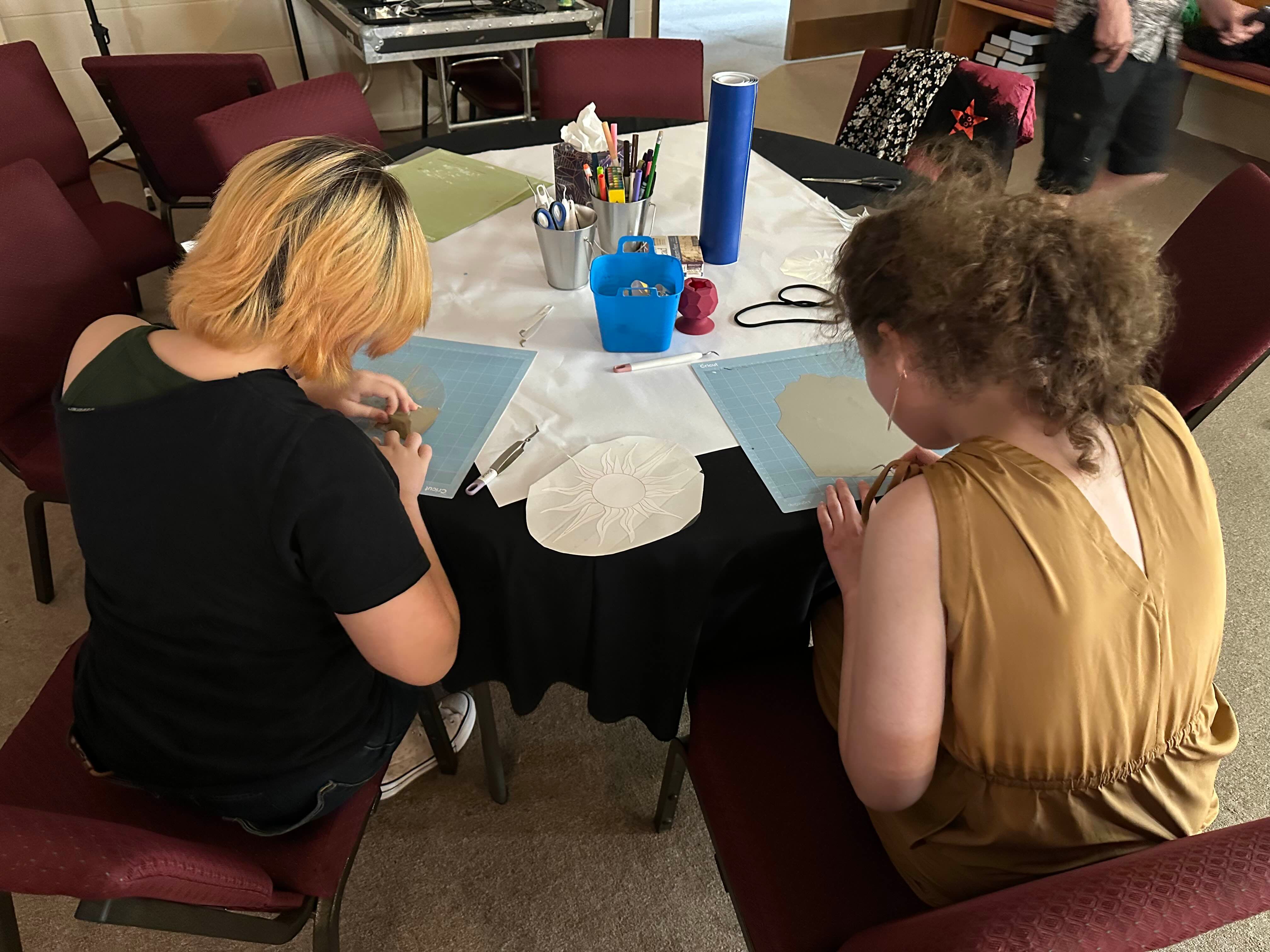 youth removing vinyl remnants from vinyl printout